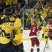 Michigan sophomore center Travis Lynch celebrates with teammate Derek DeBlois after scoring on Saturday. Michigan lost 4-3. Daniel Brenner I AnnArbor.com